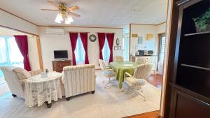 una sala de estar con una mesa y sillas en Green Lodge, en Yomitan