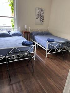 a bedroom with two beds and a zebra picture on the wall at North Chicago Spacious Home in Chicago
