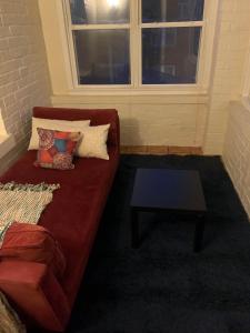a living room with a red couch and a table at North Chicago Spacious Home in Chicago
