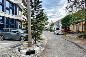 a street with cars parked next to a pole at Grace House Syariah Cikarang RedPartner in Jatirarangan