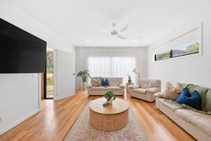 a living room with a couch and a table at Gully & Tide in Aireys Inlet
