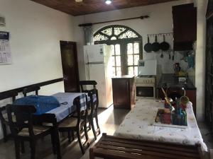 a kitchen with a table and a kitchen with a table and chairs at Green Villa in Kahawa