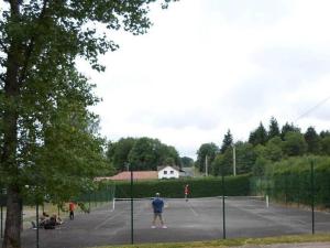a group of people playing tennis on a tennis court at Chalet confortable avec terrasse et jardin - API-1-52-889 in La Chapelle +16 photos