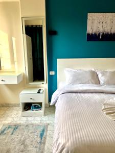 a bedroom with a white bed and a mirror at Cozy apartment in down town in Cairo