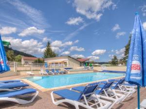 a swimming pool with chairs and umbrellas at Chalet 32m² avec Terrasse - 2 Chambres - API-1-52-939 in La Chapelle