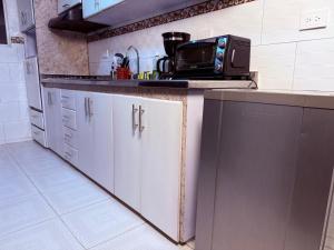 a kitchen with a counter with a microwave on it at Posada Pa'sumerce in Tibasosa +20 photos