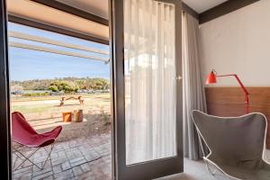 a room with a sliding glass door leading to a patio at Black Dolphin Motel in Merimbula