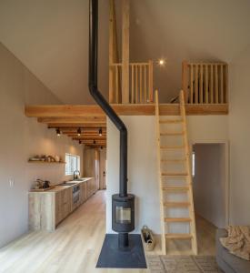 a loft conversion with a wood stove in a room at The Klover in Logan