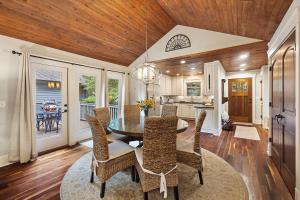 a dining room with a table and chairs and a kitchen at FR480: 480 Fiddlers Reach in Kiawah Island