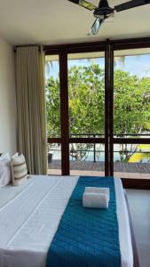 a bedroom with a large bed with a large window at Ko Lake Villa in Ahangama +278 photos