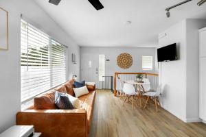 a living room with a couch and a table at Beacons Beach Cottage in Encinitas