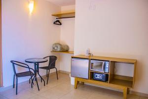 a room with a tv and a table and chairs at Hotel Majo Sayulita in Sayulita