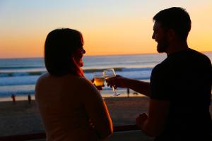 a man and woman drinking wine at the beach at Shoreline Inn...on the beach in Cayucos