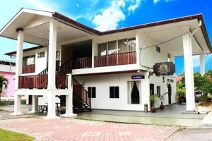 a large white building with a balcony at Kesuma Villa Exclusive Stay in Parit Raja +25 photos