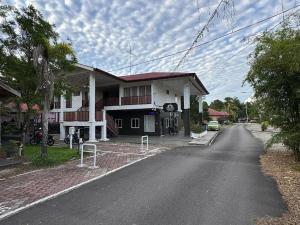 a house on the side of a road at Kesuma Villa Exclusive Stay in Parit Raja