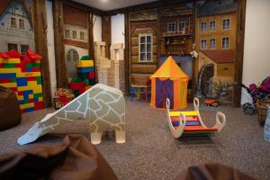 a room with a toy giraffe and a chair at Chata Františkov in Kvilda