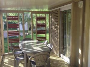 Chalet avec Terrasse à Soubès - Accès Handicapé - API-1-52-955 في Soubès: فناء على طاولة وكراسي على شرفة