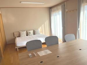 Ένα ή περισσότερα κρεβάτια σε δωμάτιο στο Cozy House Azumino