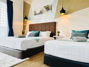 two beds sitting next to each other in a bedroom at Owl Nest Suite' at aeropod sovo in Kota Kinabalu