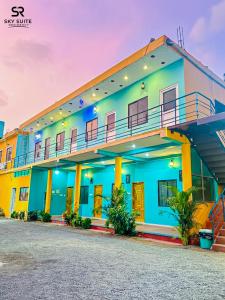 a building with a blue and yellow at sky suite residency in Auroville