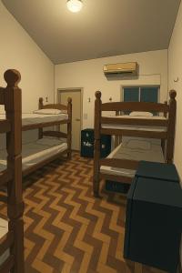 a room with three bunk beds in a room at Yolo Hostel in João Pessoa