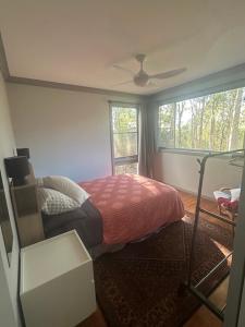 a bedroom with a bed and a window at Quiet Rural Retreat - Kimbriki in Mount George