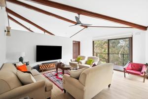 a living room with couches and a flat screen tv at Clifton Retreat large family home new renovation in Clifton Springs +7 photos