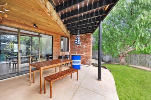 a patio with a wooden table and benches at Clifton Retreat large family home new renovation in Clifton Springs