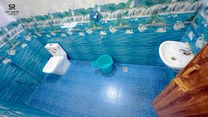 a bathroom with a sink and a toilet at sky suite residency in Auroville +31 photos