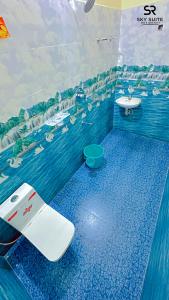 a blue bathroom with a toilet and a sink at sky suite residency in Auroville