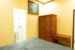 Ένα ή περισσότερα κρεβάτια σε δωμάτιο στο Villa Kubu Gitgit