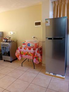 a kitchen with a table and a refrigerator at Departamento AQP in Arequipa