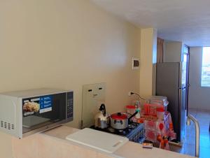 a kitchen with a stove and a microwave at Departamento AQP in Arequipa