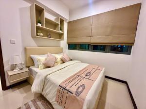 a small bedroom with a bed and a window at Trizen Colombo stylish high rise condo -Vistablu 32 in Colombo +31 photos