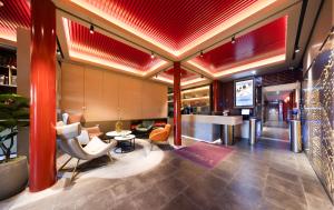 a lobby of a hotel with red ceilings and a bar at Mercure Beijing Tiananmen Square Qianmen Street in Beijing