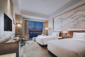 Ένα ή περισσότερα κρεβάτια σε δωμάτιο στο Wanda Realm Huangshi +16 φωτογραφίες