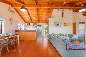 a living room with a couch and a table at Hosts on the Coast Paws & Relax Bach in Hahei