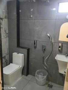 a bathroom with a toilet and a sink at Hotel Helixo Classic Kompally in Hyderabad