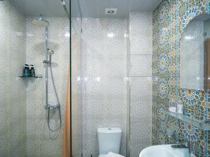 a bathroom with a shower and a toilet and a sink at Oasis Boutique in Bukhara +104 photos