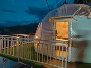 a luxury dome tent on a balcony at night at Khoj The Lake Trail in Nārkanda