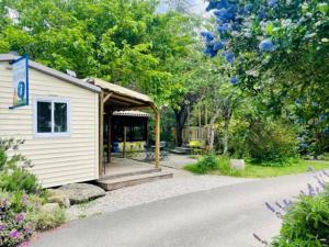 a small white building with a gazebo at Chalet Confort 6 Pers - Terrasse - API-1-52-1032 in Belloc