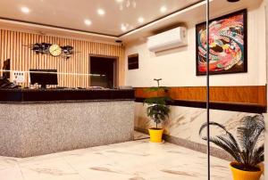 a lobby with a bar in a building at MGallery Hotel in Srinagar