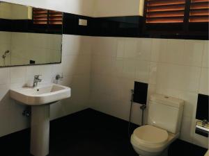 a bathroom with a sink and a toilet at Borala Lake Weligama in Weligama +11 photos