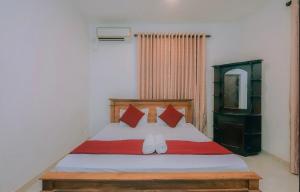 1 dormitorio con 1 cama con sábanas rojas y blancas en Hamilton View, en Negombo