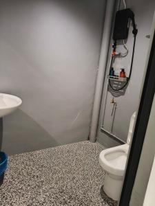 a bathroom with a toilet and a sink at travellersloft 168 in Johor Bahru