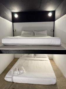 two beds in a room with two shoes on them at travellersloft 168 in Johor Bahru