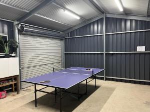 a ping pong table in a room with a garage at Hibiscus Haven in Eaton