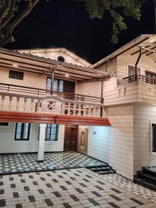 a house with a tiled courtyard in front of it at The Sparrow House 1BHK First Floor in Kumbakonam