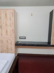 an empty room with a bed and a cabinet at The Sparrow House 1BHK First Floor in Kumbakonam +19 photos