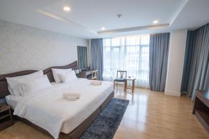 Ένα ή περισσότερα κρεβάτια σε δωμάτιο στο Avada Hotel